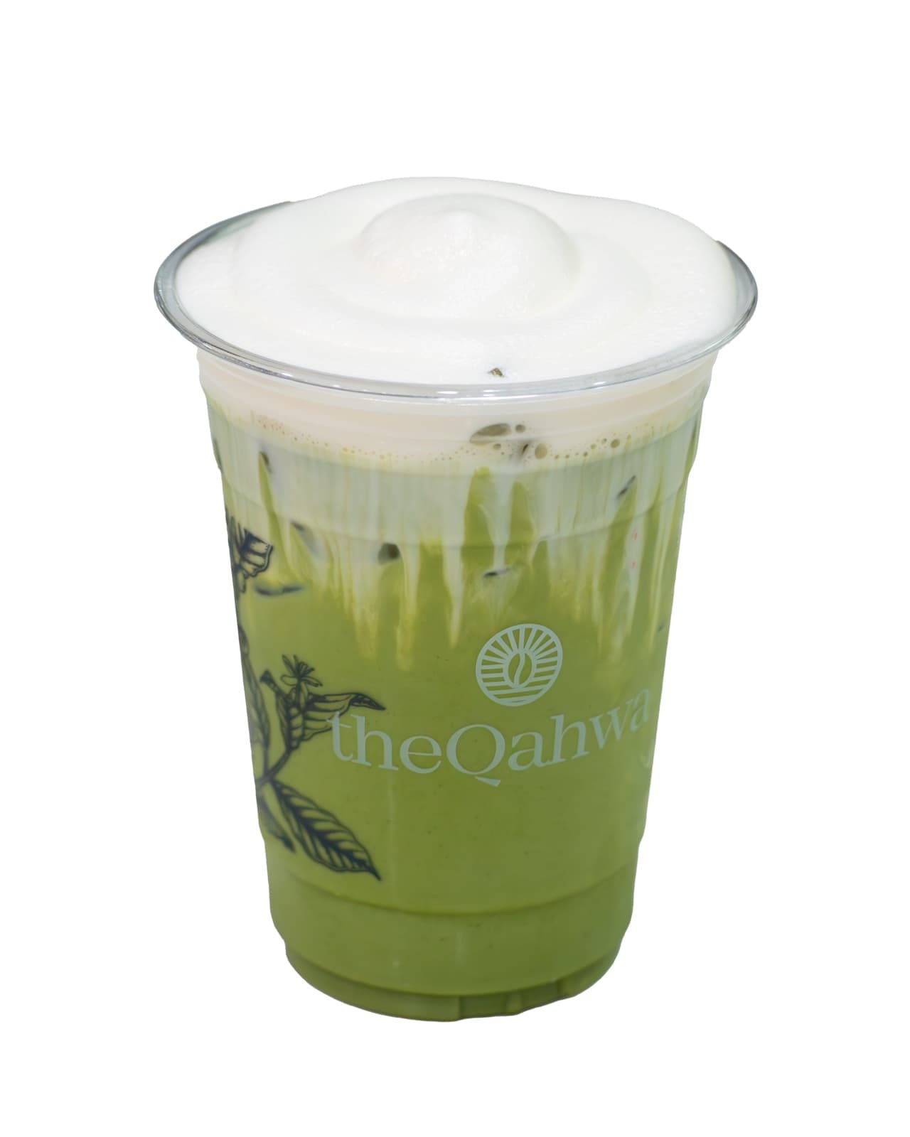 Banana Matcha in a clear theQahwa cup — bright green matcha and banana-milk base under a thick white cream cap.