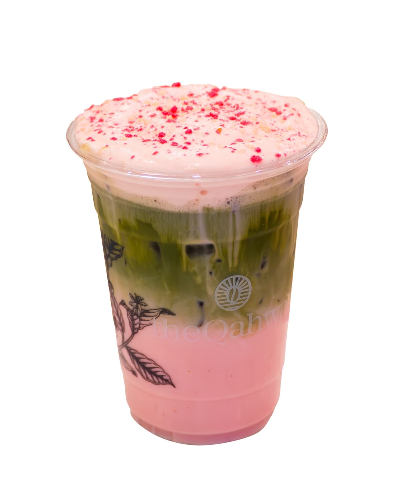 Strawberry Shortcake Matcha in a clear theQahwa cup — whisked matcha layered over strawberry cream, topped with a pink shortcake foam and red sprinkles.