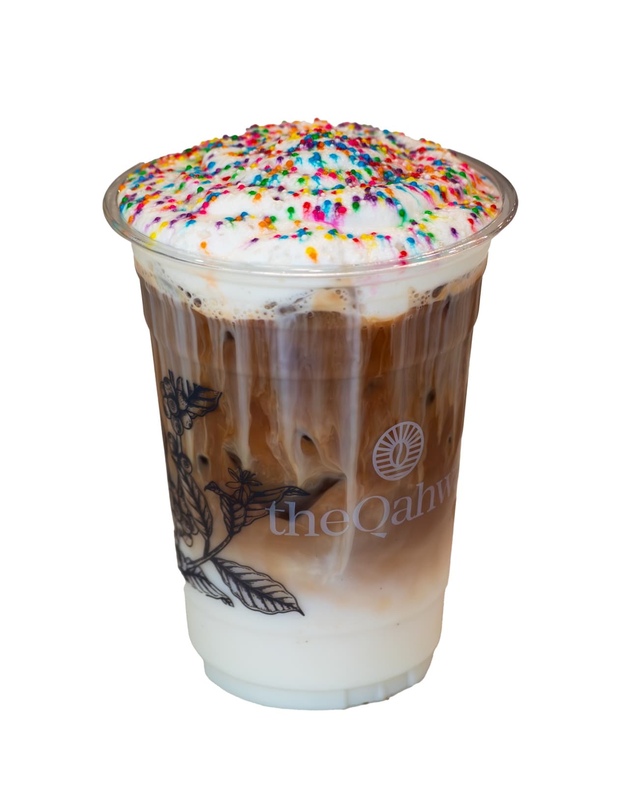 Sugar Cookie Latte in a clear theQahwa cup — espresso and milk over ice with a thick sugar-cookie cream foam, finished with rainbow sprinkles.